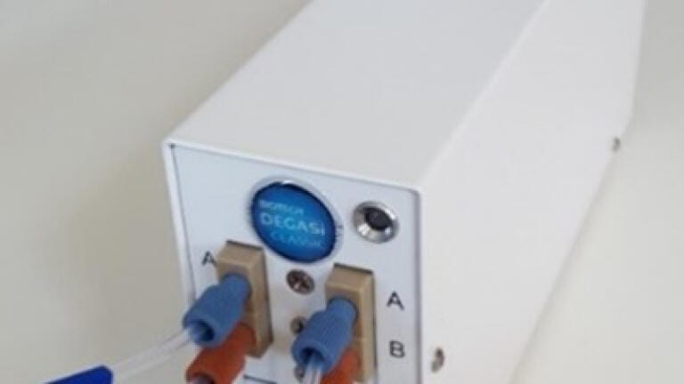 Inline degasser reduces anomalies in reagent dispensing
